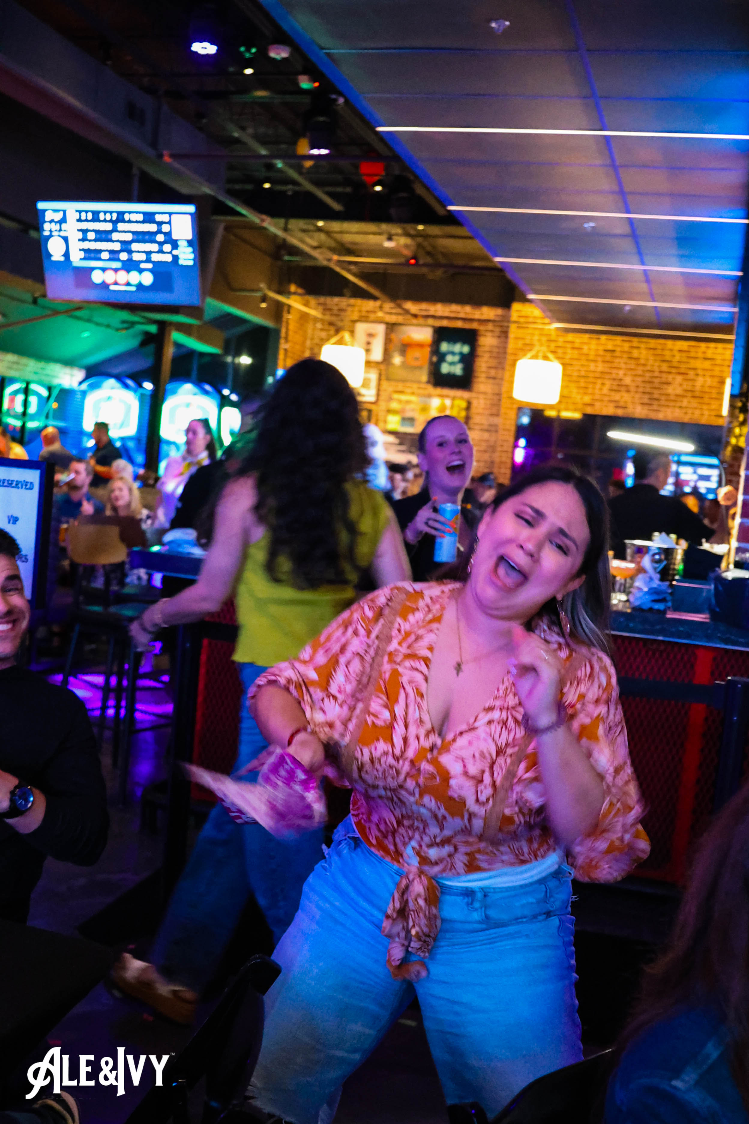 A guest celebrating on the dance floor at Ale & Ivy