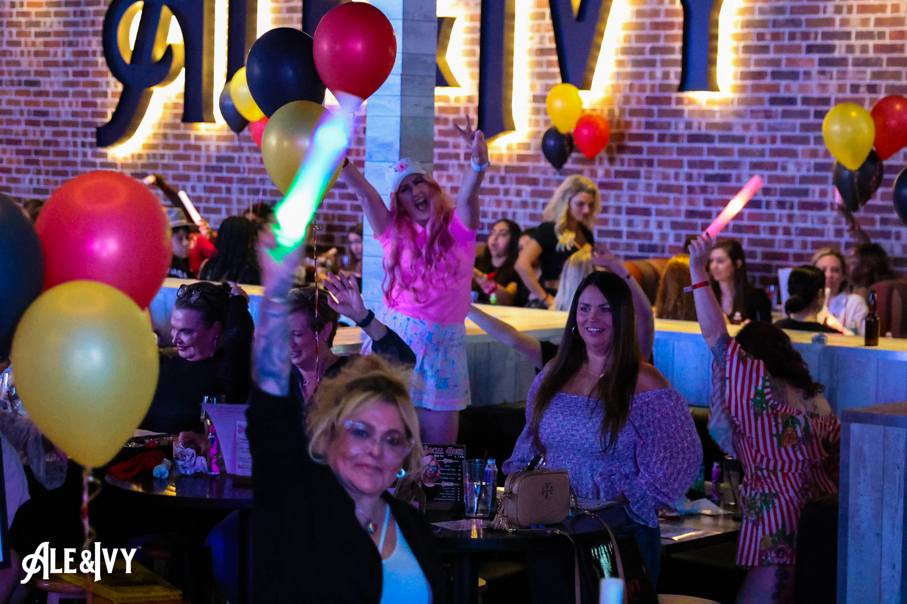 Guests cheering together at Ale & Ivy