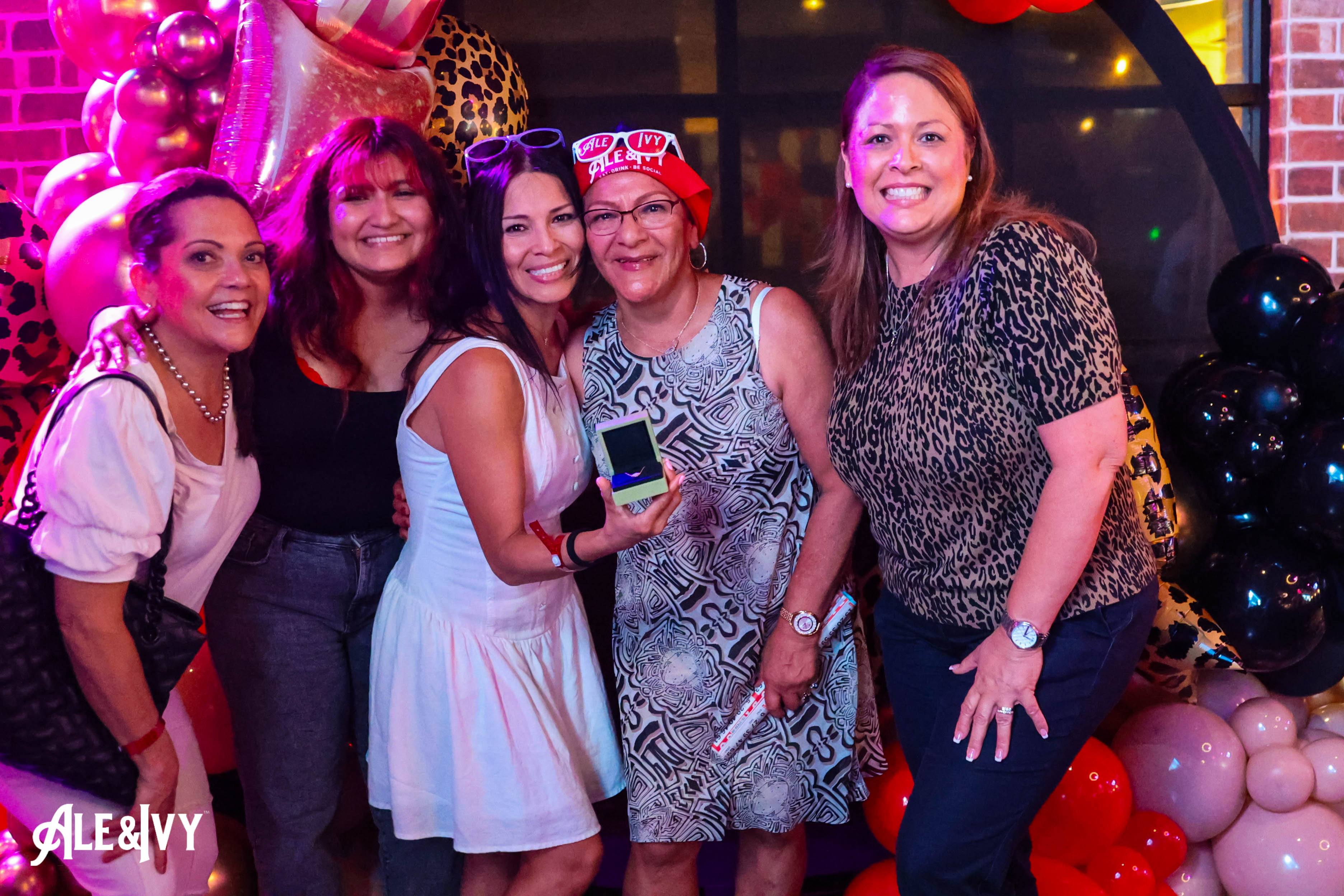 Friends posing together during an Ale & Ivy event